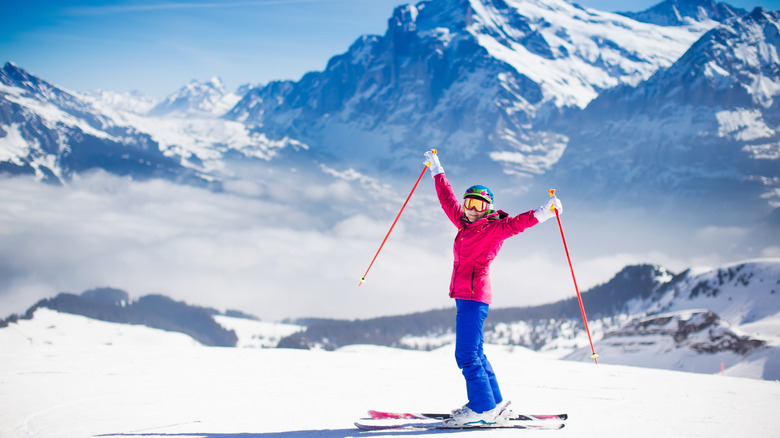 Skier in hot pink jacket on the mountains of Austria