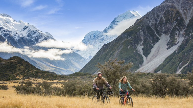 Couple bicycling through the mountains of New Zealand