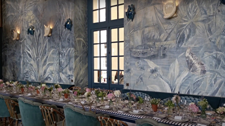 Interior in Café Lapérouse with flowers and plates on long table