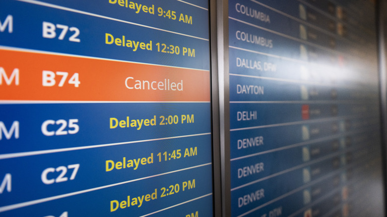 Delayed and canceled flights on departures board