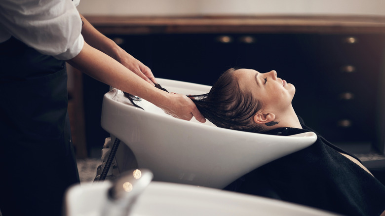 woman getting her hair washed at a salon