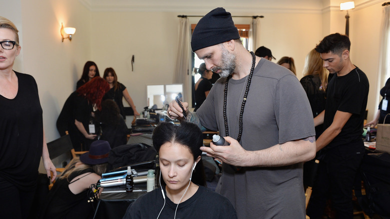 Jon Reyman cutting hair at LA Fashion week in 2016