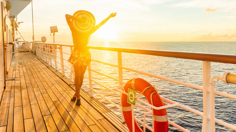 Woman enjoying sunset on ship