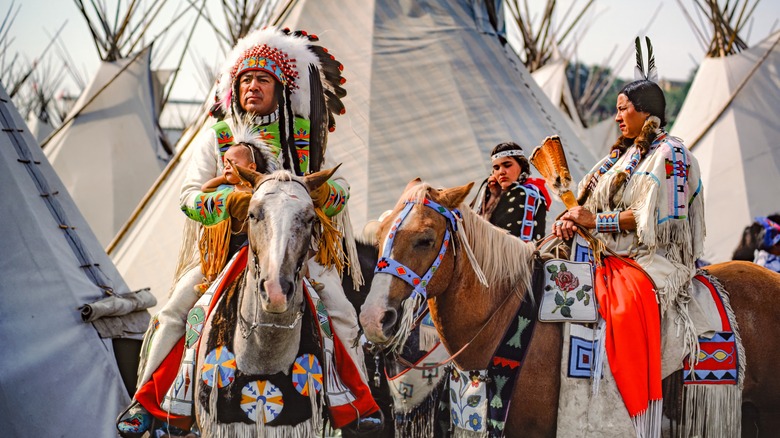 Indians on horseback at the grand tribal village at the pendleton roundup