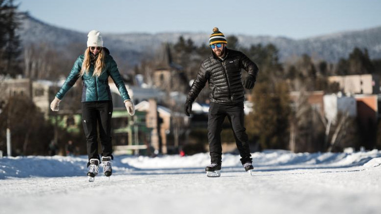 Couple skating on Mirror Lake in Lake Placid.