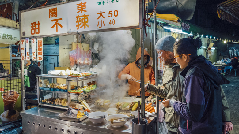 Couple shopping for street food