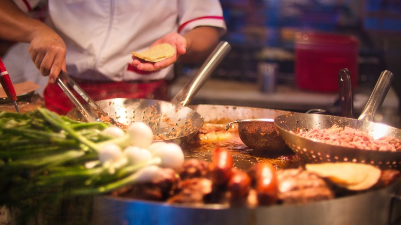 Street food vendor making tacos in Mexico City