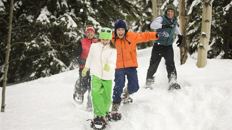 Family goes snowshoeing in the winter.