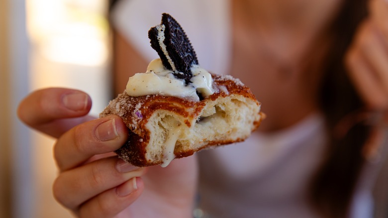 Person holding malasada