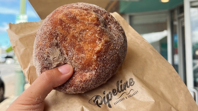 Person holding Pipeline malasada