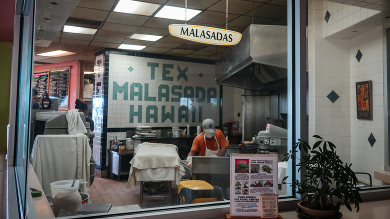 Person making malasadas at Tex