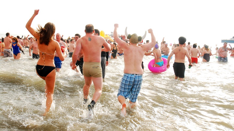 Crowds rushing into the water near Coney Island, New York for the annual polar bear plunge