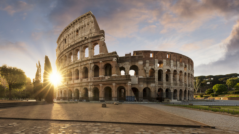 Sun shining behind the Roman Colosseum