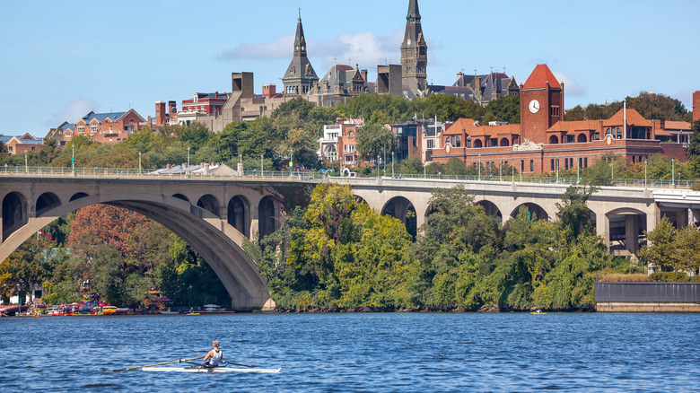 Kayaker paddles past Georgetown, DC bridge