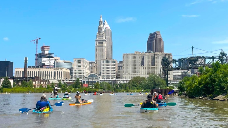 Paddlers on Cuyahoga River Head toward city skyline