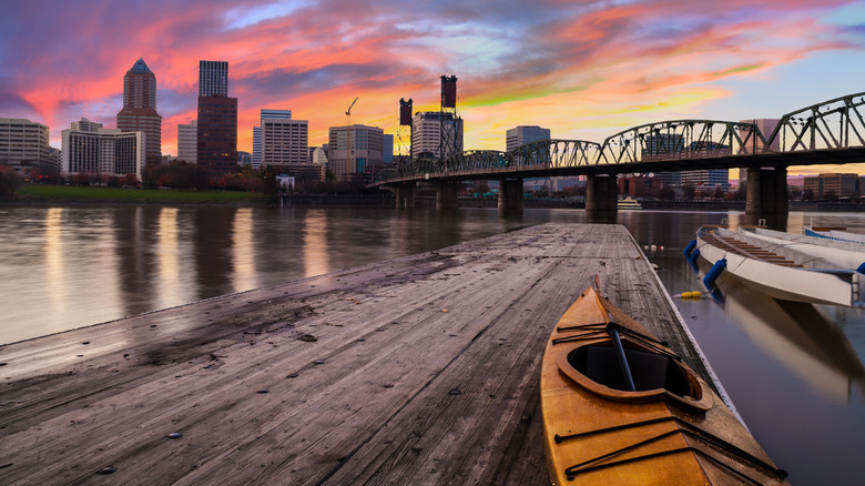 Kayak sits on Willamette River dock overlooking Portland skyline