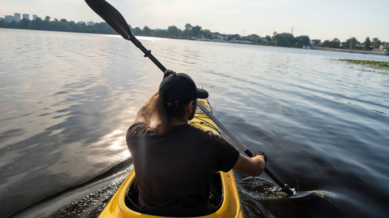 Male kayaker on an urban lake