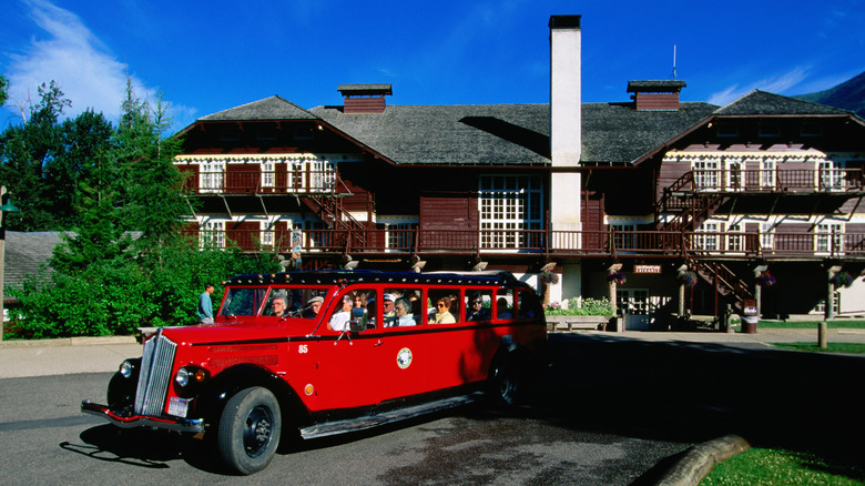 old-fashioned red bus outside Lake McDonald Lodge