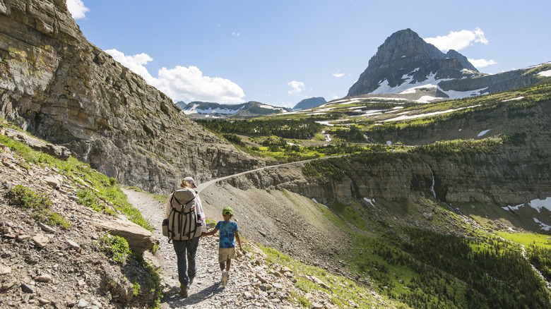 woman and child hiking on a trail in Glacier National Park