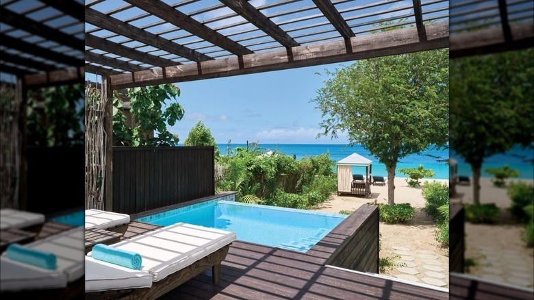 Lounge chairs and plunge pool by beach at Keyonna Beach Resort, Antigua