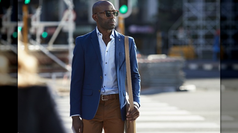 man wearing brown shoulder bag