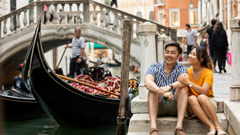 Couple by gondola in Venice