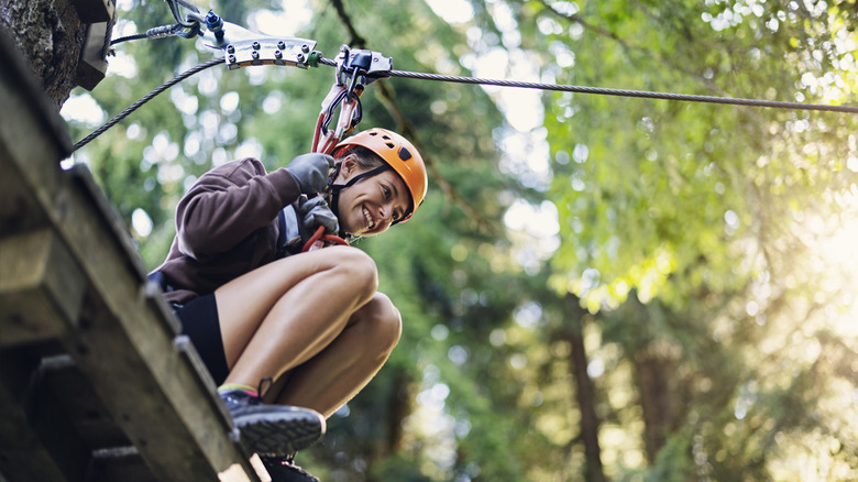 Teenage girl zip-lining