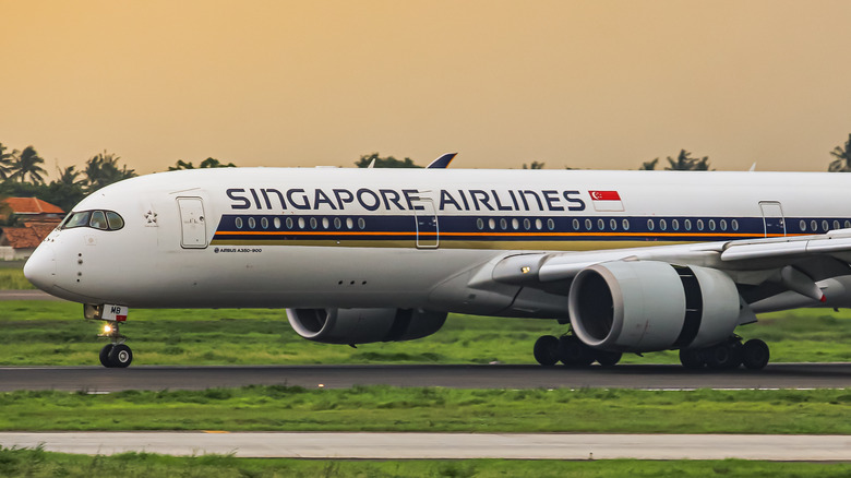 Singapore Airlines plane on runway at sunset