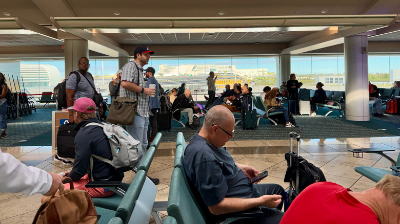 People waiting in departure lounge at Orlando International Airport