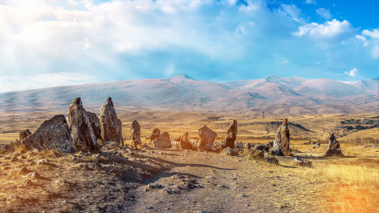 Megalithic stones of Carahunge, Armenia under a blue sky with clouds