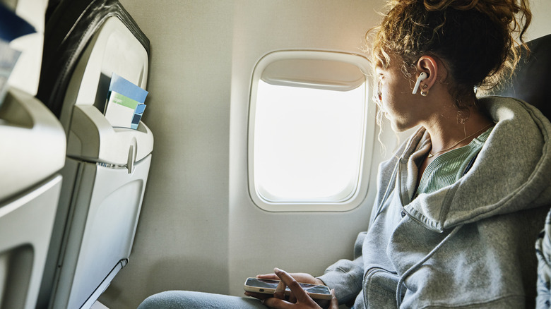 A person looking out the plane window