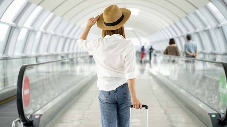 A woman walking through an airport