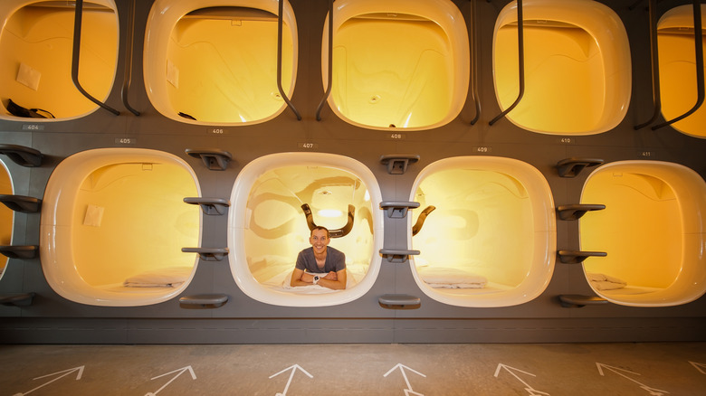 Man in a capsule hotel in Japan