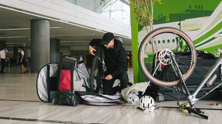 Man disassembling bike at airport