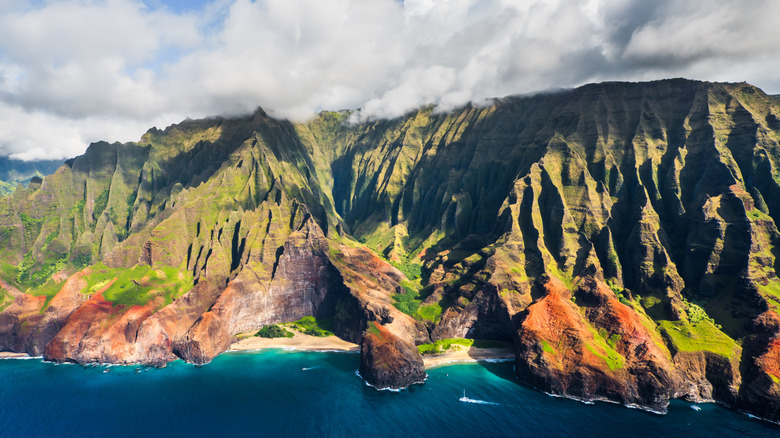 Na Pali Coast in Kauai with clouds casting shadows on cliffside