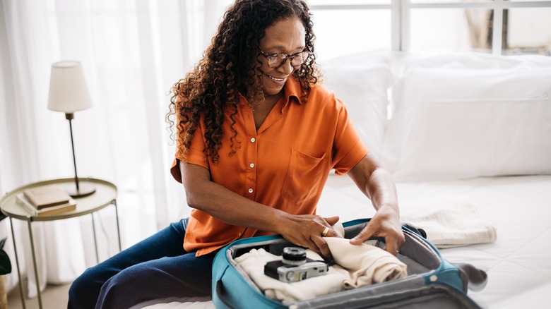 Woman packing a carry-on bag