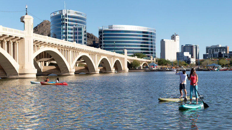 People on paddleboards and canoes