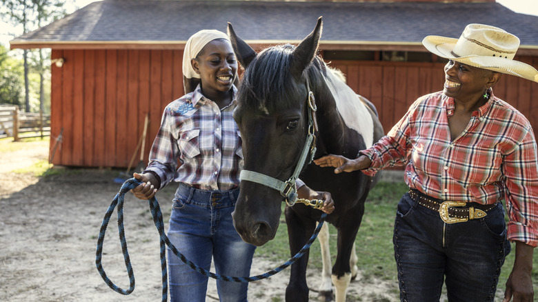 Two women with a horse