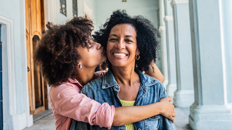 Daughter kissing mother on cheek