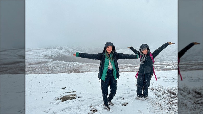 Two women pose in snow