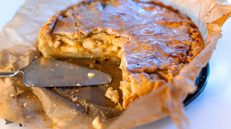 An Apple Pie Baked in a Paper Bag with a slice missing