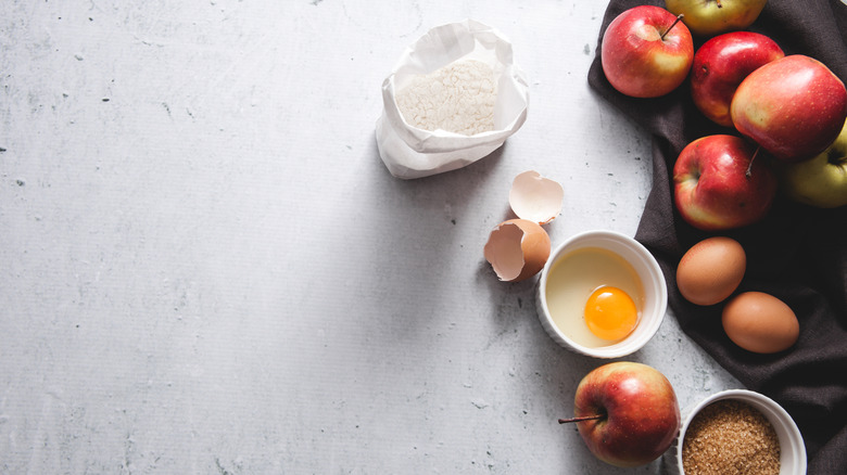 Apple pie baking ingredients displayed on a clean surface.