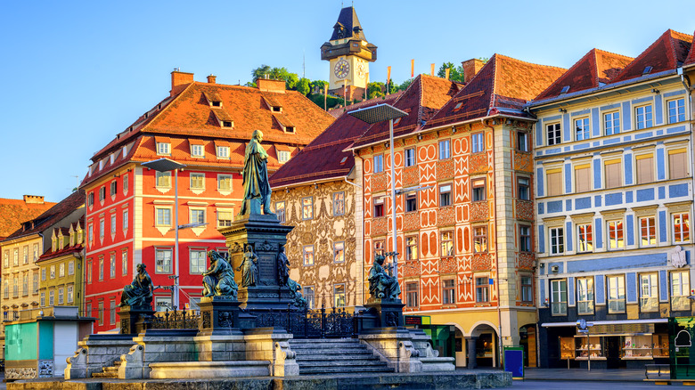 Clocktower in Graz with colorful buildings in foreground