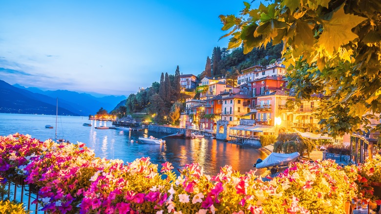 Town of Varenna at dusk with colorful flowers in foreground