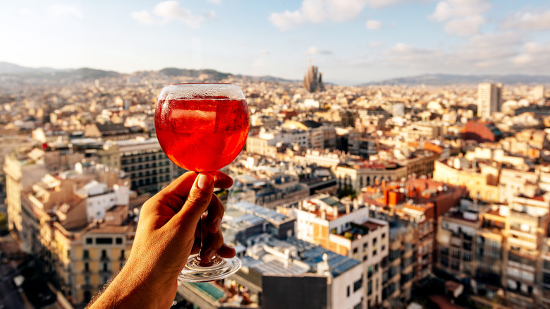 A cockail toast the Barcelona skyline