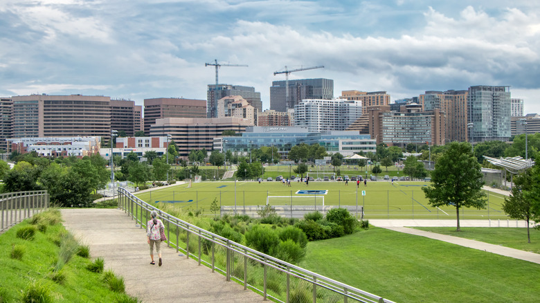 A woman walking in Arlington, Virginia, with cityscape in the background