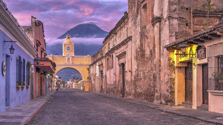 Santa Catalina Arch in Antigua, Guatemala, with the Agua Volcano in the background.