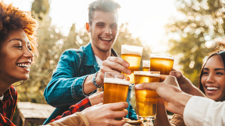 People toasting pints of beer in a German beer garden