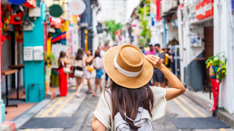 Woman walking among shops in Haji Lane