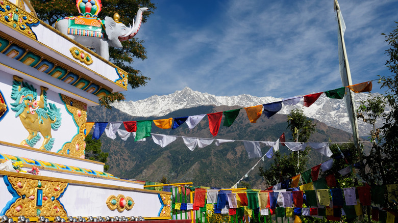 Kalachakra Temple in Dharamshala with prayer flags and mountains in background